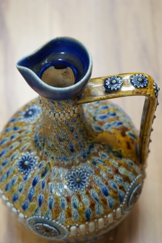 A Doulton Kingsware ewer and a Doulton stoneware jug, c.1882, tallest 29cm high. Condition - chip to Kingsware ewer lip and part of lozenge on body of jug missing, base of handle reglued and rim of jug crazed and split